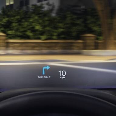 Head-Up Display detail of 2026 Honda Accord driving along neighborhood street at night.