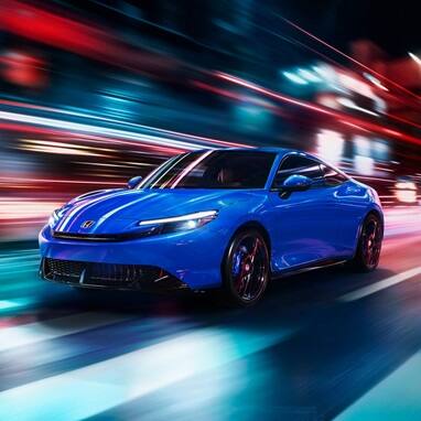 2027 Honda Prelude in Boost Blue Pearl, 3/4 front view driving with streaky light around it (exhilarating hybrid coupe).